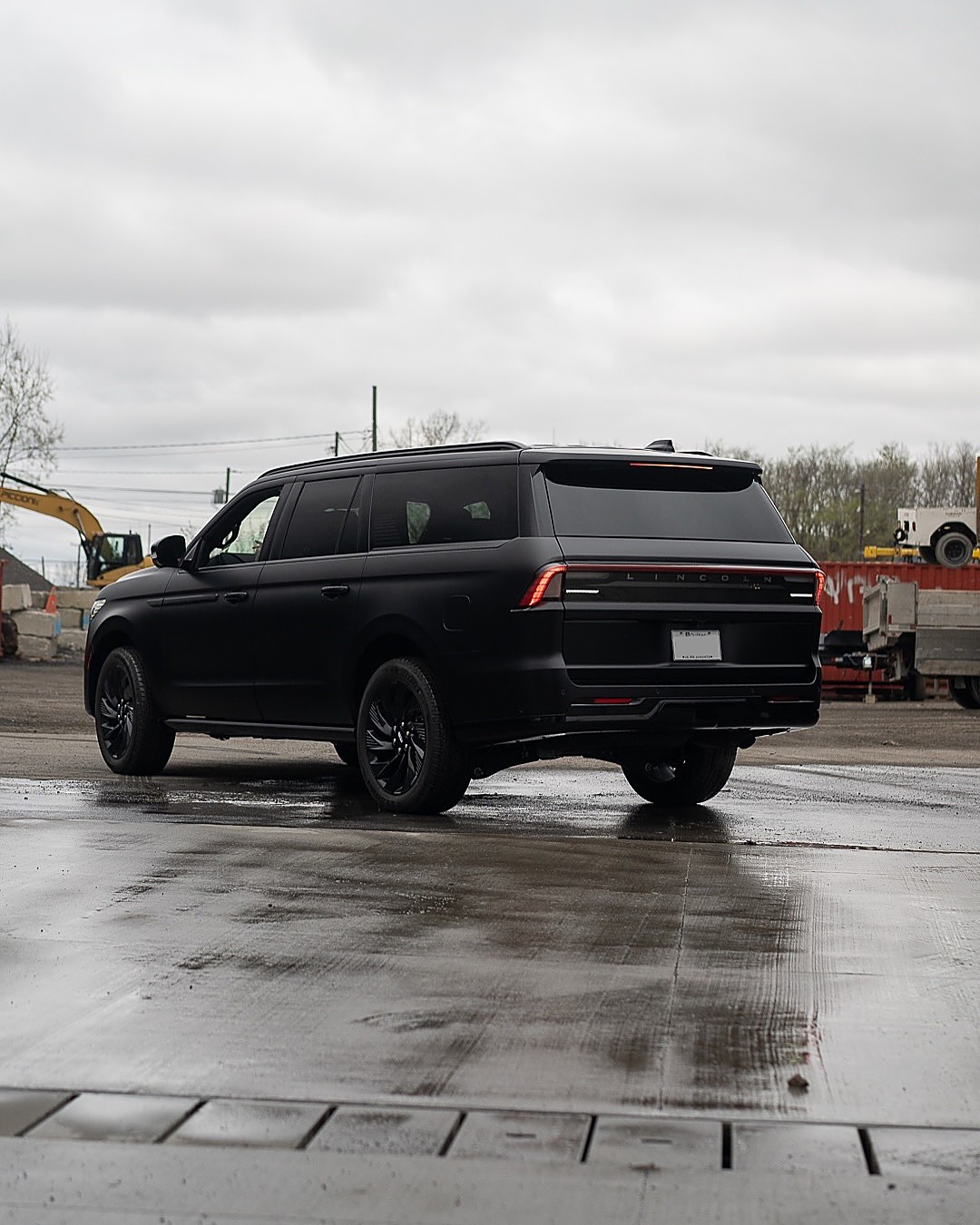 Navigator from the rear on wet pavement